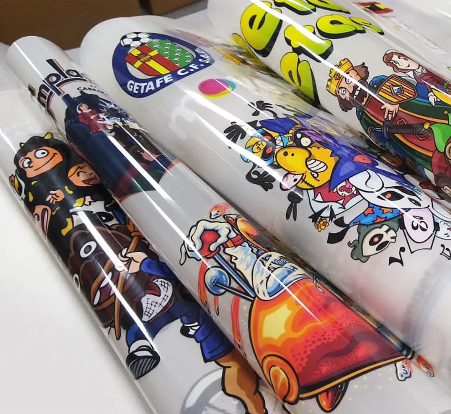 Colorful cartoon-style tubes with various designs and text on a white background